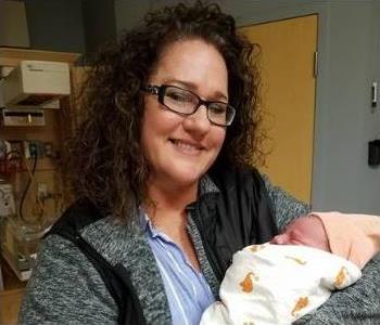 Denise Frost, an owner, holding another one of her Grandbabies.